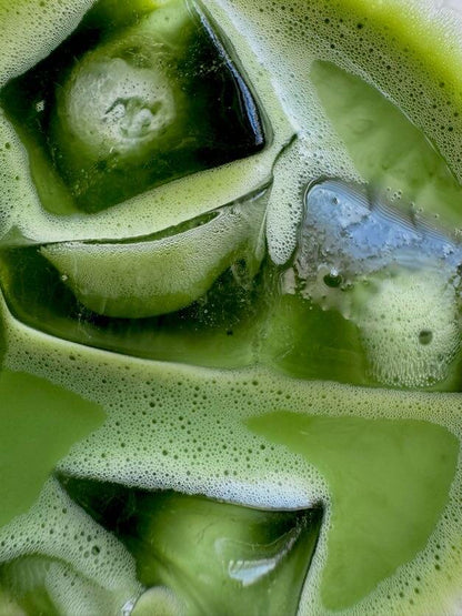 Closeup shot of iced matcha latte using organic vibrant matcha powder sourced from japanese farmers